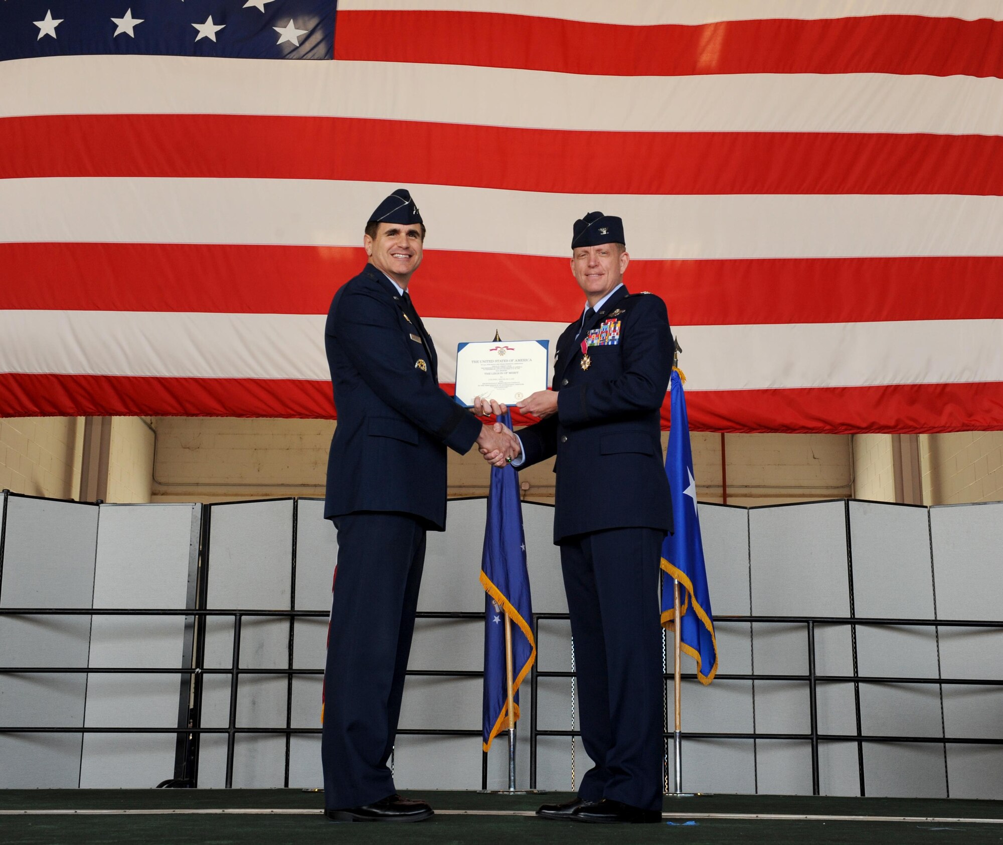 Col. Douglas lee (right) out-going 9th Reconnaissance Wing commander accepts the Legion of Merit medal during a change of command ceremony at Beale Air Force Base, California July 8, 2016. Maj. Gen. Bradford Shwedo (Left) 25th Air Force commander, was the presiding official for the event. (U.S. Air Force photo by Staff Sgt. Robert M. Trujillo)