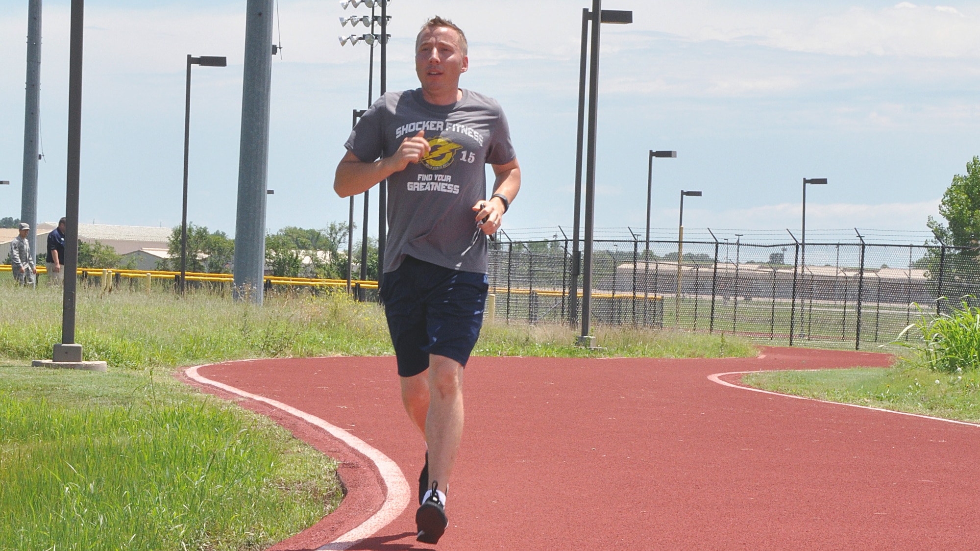 Maj. Brian Doom, 18th Air Refueling Squadron assistant director of operations, runs along the outdoor track July 8, 2016, McConnell Air Force Base, Kansas. Doom often spends his lunch breaks performing physical training to maintain his fitness levels. (U.S. Air Force photo by Senior Airman Preston Webb)