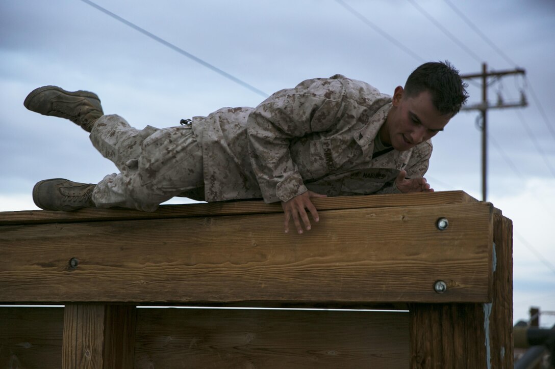 Lance Cpl. Joseph Sanchez III, motor vehicle operator, Headquarters and Service Company, 7th Marine Regiment, vaults over the Log Wall at an obstacle course aboard the Marine Corps Air Ground Combat Center, Twentynine Palms, Calif., July 1, 2016. (Official Marine Corps photo by Lance Cpl. Dave Flores/Released)