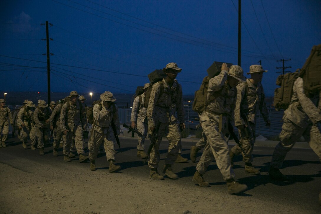 Marines with Headquarters and Service Company, 7th Marine Regiment, hike to an obstacle course aboard the Marine Corps Air Ground Combat Center, Twentynine Palms, Calif., July 1, 2016. (Official Marine Corps photo by Lance Cpl. Dave Flores/Released)