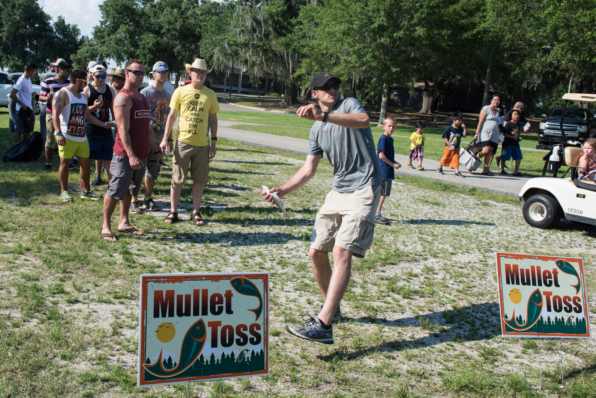 Keesler personnel participate in a mullet toss competition during the Celebration of Our Nation event at Marina Park July 2, 2016, on Keesler Air Force Base, Miss. The event also included a golf scramble, fireworks display and music performances. (U.S. Air Force photo by Marie Floyd/Released)