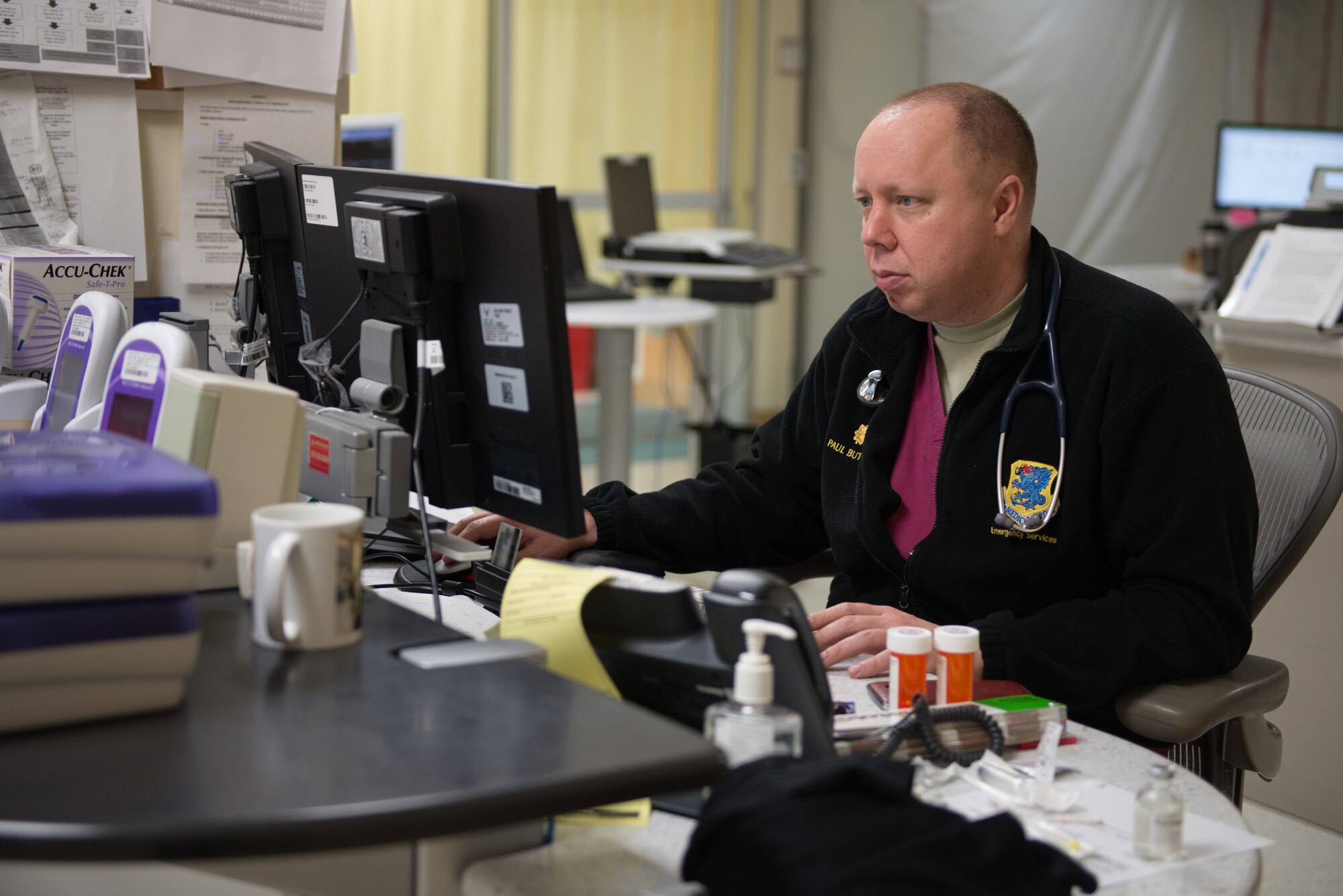 Maj. (Dr.) Paul Butts, 81st Medical Operations Squadron physician, updates patient records in the emergency services department at the Keesler Medical Center July 1, 2016, on Keesler Air Force Base, Miss. Keesler’s emergency room, which is open 24/7, sees around 2,000 patients monthly and is one of several clinics in the medical center. (U.S. Air Force photo by Marie Floyd/Released)