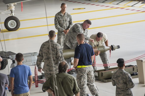 Airman 1st Class Tyler Hayden, 33rd Aircraft Maintenance Squadron weapons load crew member, and Staff Sgt. Brody Bundy, 33rd AMXS weapons load crew team chief, assemble a GBU-12 during a weapons load competition July 8, 2016, at Eglin Air Force Base, Fla. The load crew competition showcased the efficiency of load crew teams to safely and properly arm an F-35 within time constraints. (U.S. Air Force photo by Senior Airman Stormy Archer/Released)