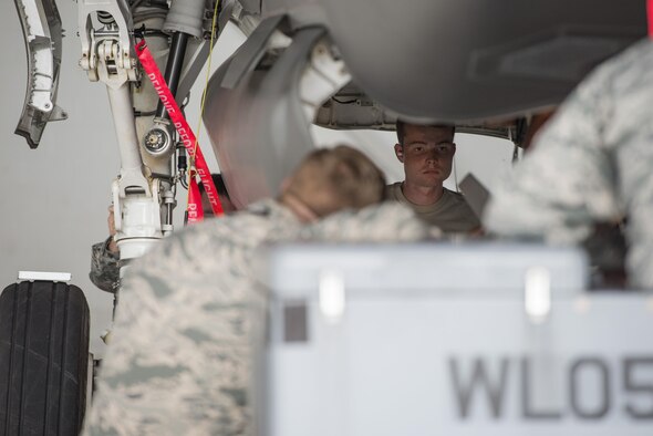 Airman Dylan Snead, 33rd Aircraft Maintenance Squadron load crew member, loads a GBU-12 into an F-35 during a weapons load crew competition July 8, 2016, at Eglin Air Force Base, Fla. The ability to quickly and safely load an aircraft with munitions is integral to provide combat-ready jets to combatant commanders. (U.S. Air Force photo by Senior Airman Stormy Archer/Released)