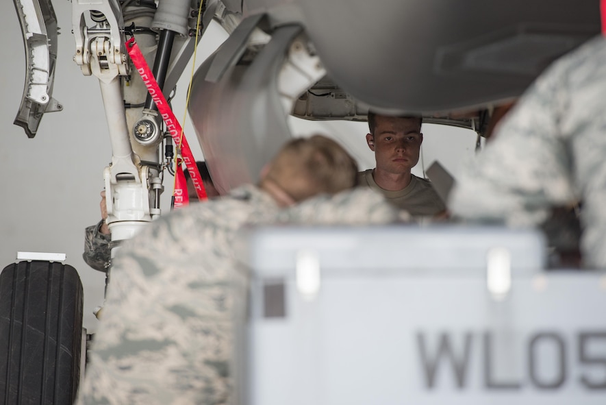 Airman Dylan Snead, 33rd Aircraft Maintenance Squadron load crew member, loads a GBU-12 into an F-35 during a weapons load crew competition July 8, 2016, at Eglin Air Force Base, Fla. The ability to quickly and safely load an aircraft with munitions is integral to provide combat-ready jets to combatant commanders. (U.S. Air Force photo by Senior Airman Stormy Archer/Released)