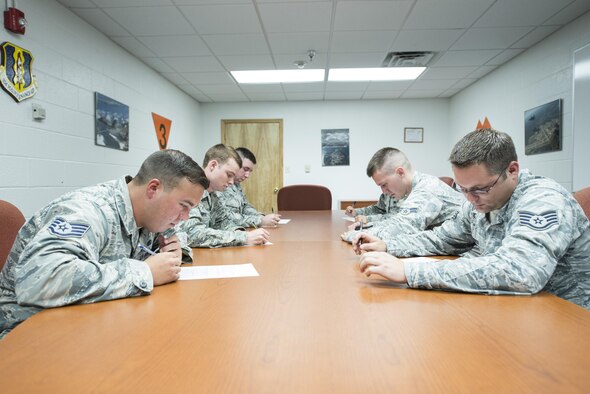 Members of the 33rd Aircraft Maintenance Squadron take a written exam during a weapons load crew competition July 8, 2016, at Eglin Air Force Base, Fla. The written exam tests the Airmen’s knowledge on weapons loading operations and safety standards. (U.S. Air Force photo by Senior Airman Stormy Archer/Released)