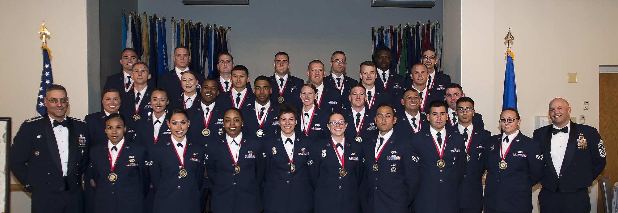 Col. Stephen Kravitsky, 90th Missile Wing commander, and Chief Master Sgt. Jeffery Steagall, 90th MW command chief, pose with the graduating Airman Leadership School Class 16-F students in the Trail's End Event Center on F.E. Warren Air Force Base, Wyo., July 6, 2016. Enlisted Airmen must complete the rigorous professional military education course to become supervisors of other Airmen. (U.S. Air Force photo by Senior Airman Jason Wiese)