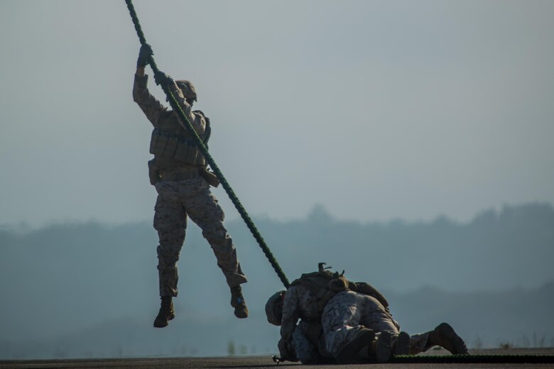 Marines with 2nd Battalion, 5th Marine Regiment, Weapons Company, Scout Sniper Platoon, fast rope from an MV-22B Osprey with Marine Medium Tiltrotor Squadron (VMM) 164 aboard Marine Corps Base Camp Pendleton, Calif., June 30. The ability to fast rope enables Marines to insert into an area or structure without landing the aircraft, eliminating the need for a landing zone. (U.S. Marine Corps photo by Sgt. Lillian Stephens/Released)