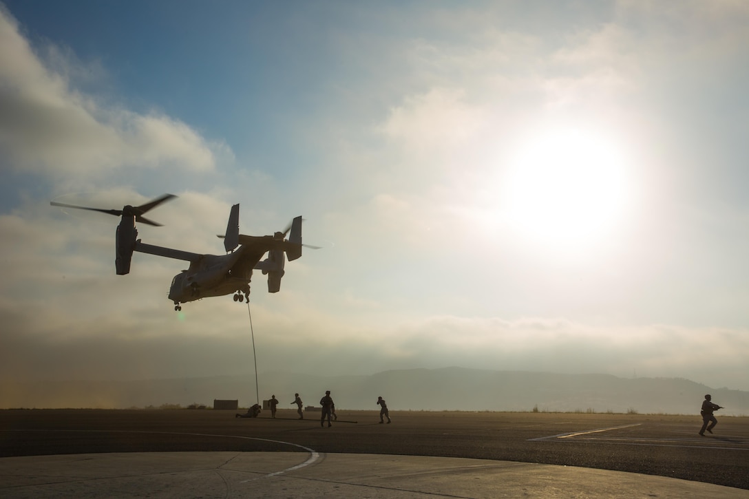 Marines with 2nd Battalion, 5th Marine Regiment, Weapons Company, Scout Sniper Platoon, fast rope from an MV-22B Osprey with Marine Medium Tiltrotor Squadron 164 aboard Marine Corps Base Camp Pendleton, Calif., June 30. The ability to fast rope enables Marines to insert into an area or structure without landing the aircraft, eliminating the need for a landing zone. (U.S. Marine Corps photo by Sgt. Lillian Stephens/Released)