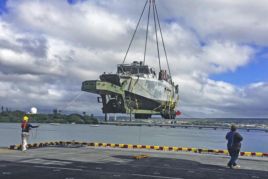 A crew offloads a riverine command boat from the amphibious assault ship USS America for participation in Rim of the Pacific 2016 at Joint Base Pearl Harbor-Hickam, Hawaii, July 6, 2016. Navy photo by Lt. Travis Terran