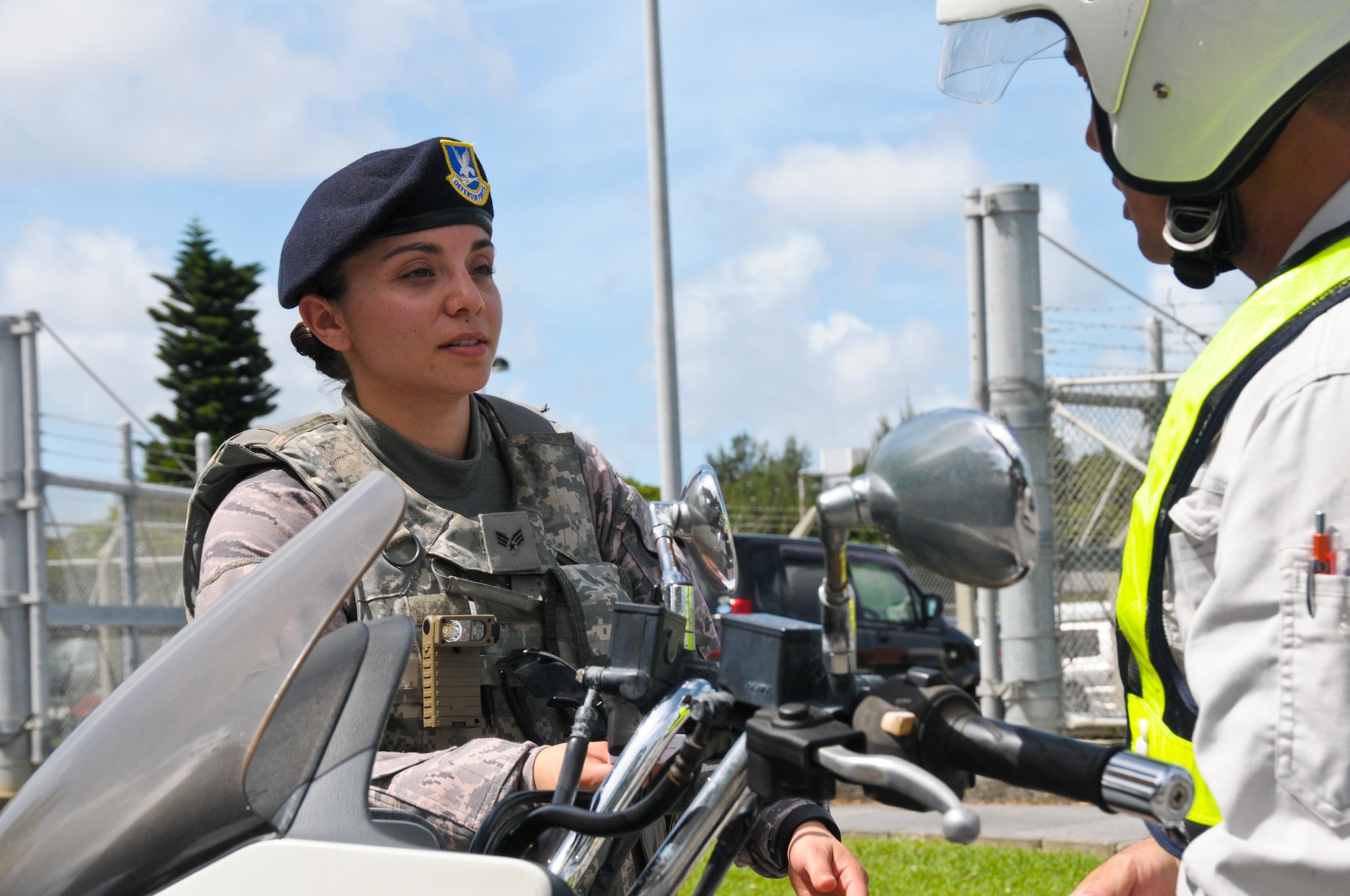 Senior Airman Dominique Castillo, 944th Security Forces Squadron member, checks a visitor’s credentials in order to allow him base access June 28, 2016, at Gate 1 at Kadena Air Base, Okinawa.  A native Arizonian, Castillo has been a Reservist with the 944th for four years and the opportunity to do an off-station annual tour is valuable to her. The 18th Security Forces Squadron capitalized on the extensive experience 944 SFS members brought during their annual tour by seamlessly integrating them into all of their flights. (U.S. Air Force photo by Staff Sgt. Nestor Cruz)