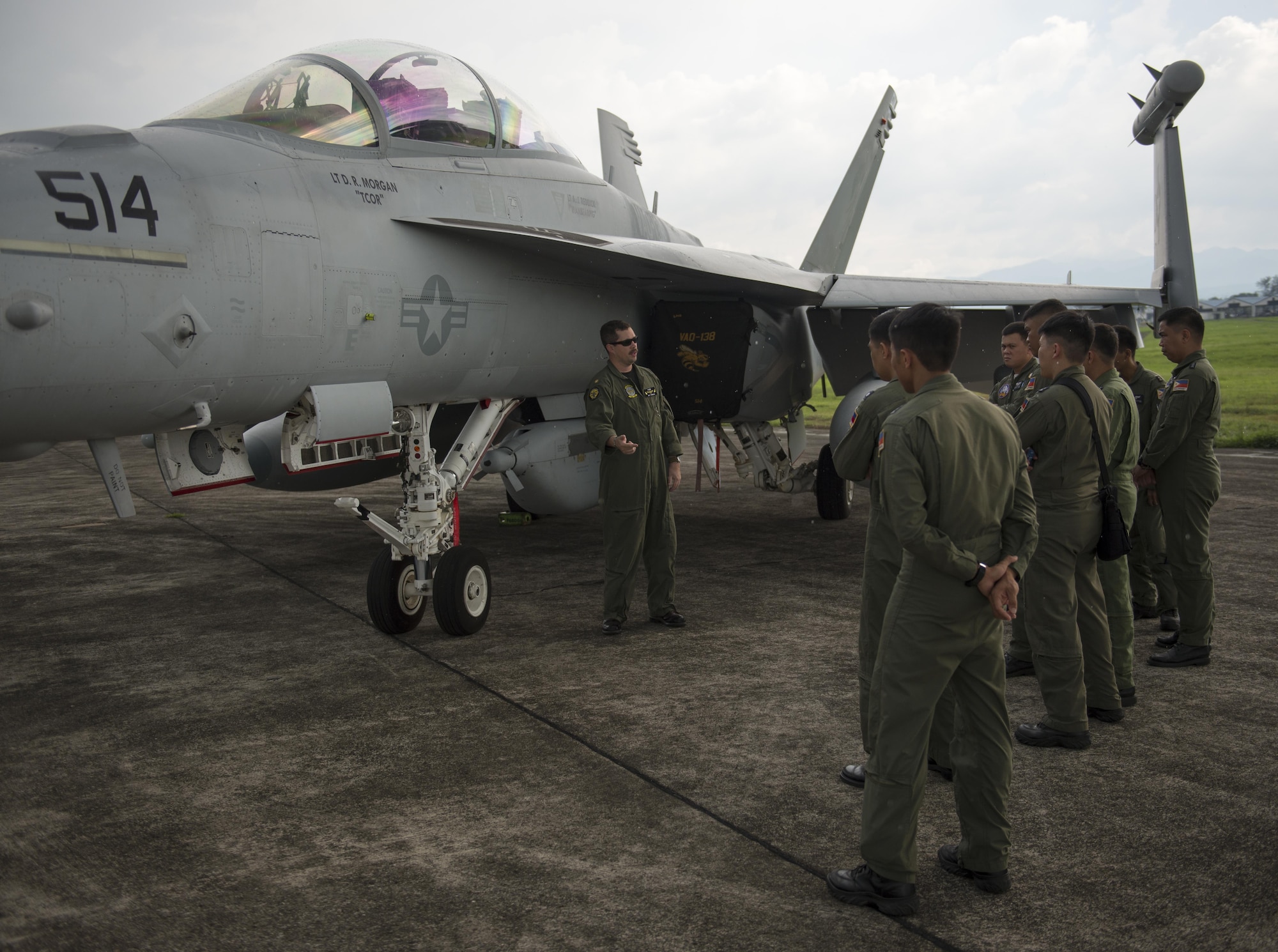 U.S. Navy LCDR Jeff Pinkerton, an EA-18G Grolwer pilot assigned to Electronic Attack Squadron 138, speaks with a group of Philippine Air Force pilots assigned to Clark Air Base, Philippines, June 28, 2016. U.S. forces arrived in the Philippines to excercise bilaterally with the Armed Forces of the Philippines and support routine operational missions that enhance regional maritime domain awareness. (U.S. Air Force photo by Capt. Elias Zani/released)
