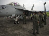 U.S. Navy LCDR Jeff Pinkerton, an EA-18G Grolwer pilot assigned to Electronic Attack Squadron 138, speaks with a group of Philippine Air Force pilots assigned to Clark Air Base, Philippines, June 28, 2016. U.S. forces arrived in the Philippines to excercise bilaterally with the Armed Forces of the Philippines and support routine operational missions that enhance regional maritime domain awareness. (U.S. Air Force photo by Capt. Elias Zani/released)
