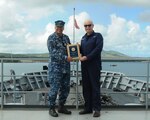 160629-N-JD834-004 SANTA RITA, Guam (June 29, 2016) Capt. Mark A. Prokopius, commanding officer of the submarine tender USS Emory S. Land (AS 39), left, and Military Sealift Command Civilian Mariner Michael S. Flanagan, officer-in-charge aboard the Emory S. Land, right, pose on the forecastle of Emory S. Land, showcasing a newly received plaque after winning the Fiscal Year 2015 Chief of Naval Operations Environmental Quality Award for the Afloat 2015 Military Sealift Command category. Emory S. Land is one of two forward deployed expeditionary submarine tenders home-ported in Guam, conducting maintenance on submarines and surface ships in the U.S. 5th and 7th Fleet areas of operations. (U.S. Navy photo by Mass Communication Specialist 3rd Class Michael Doan/RELEASED)