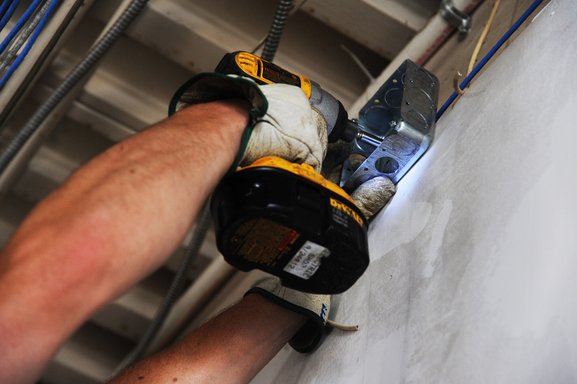 U.S. Air Force Senior Airman Eric Miller, a 509th Civil Engineer Squadron electrical systems journeyman, mounts a four-inch square outlet box to the wall of the new Airman’s Attic at Whiteman Air Force Base, Mo., July 5, 2016. The Airman’s Attic is scheduled to open at its new location on August 19, 2016. (U.S. Air Force photo by Airman 1st Class Michaela R. Slanchik)