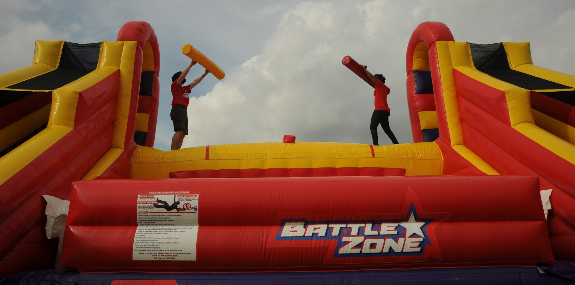 U.S. Air Force Brig. Gen. Paul W. Tibbets IV, the 509th Bomb Wing (BW) commander, left, and Chief Master Sgt. Melvina Smith, 509th BW command chief, right, prepare to spar on the inflatable jousting challenge during the Independence Day Celebration at Whiteman Air Force Base, Mo., June 30, 2016. More than 10 inflatable activities and a zip line were available to guests at the event. (U.S. Air Force photo by Senior Airman Danielle Quilla)