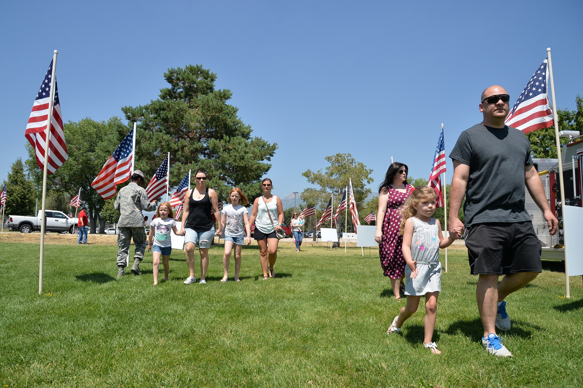 Military members and their families arrive at the Salute to Our Nation's Defenders Picnic July 8 at Centennial Park.. The free picnic, provided by the Top of Utah Military Affairs Committee, featured musical entertainment as well as activities for all ages. (U.S. Air Force photo by R. Nial Bradshaw)
