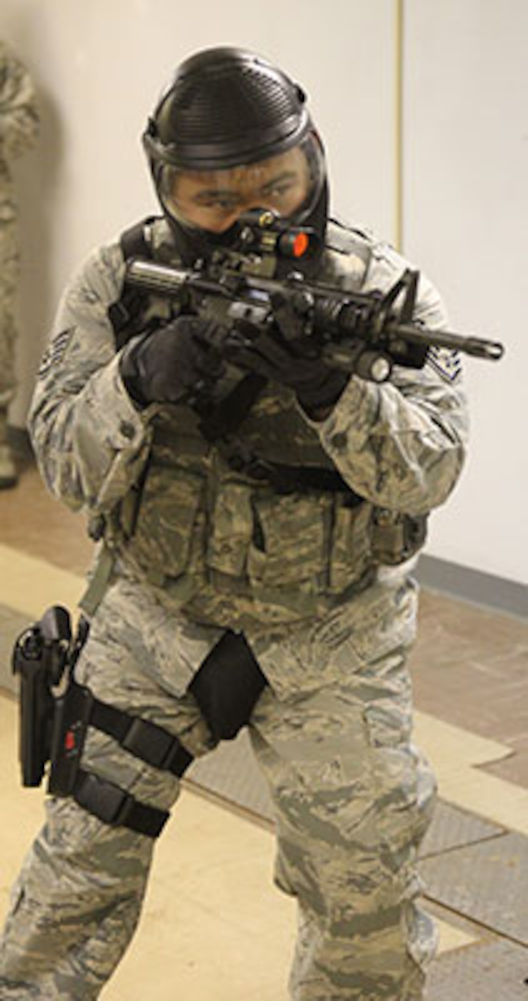 Staff Sgt. Bon Albana with the 72nd Security Forces Squadron demonstrates clearing tactics during last May’s Police Week activities at a Tinker AFB base training facility. The defenders have introduced paint marker rounds in training to help make it more realistic. (Air Force photo by Tech. Sgt. Timothy Nesbitt/Released)