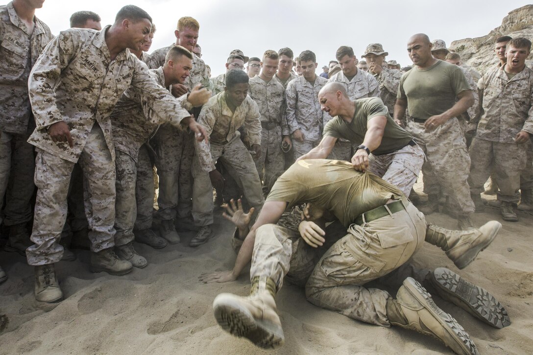 Marines grapple during Highlanders Night at Marine Corps Base Camp Pendleton, Calif., June 30, 2016. The Marines are assigned to 1st Armored Reconnaissance Battalion, which holds the annual event to celebrate its history while building camaraderie through competitive events. Marine Corps photo by Lance Cpl. Danny Gonzalez
