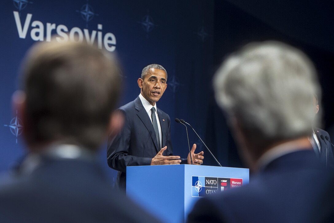 President Barack Obama addresses reporters as Defense Secretary Ash Carter, left, and Secretary of State John Kerry look on at the NATO Summit in Warsaw, Poland, July 8, 2016. DoD photo by Navy Petty Officer 1st Class Tim D. Godbee