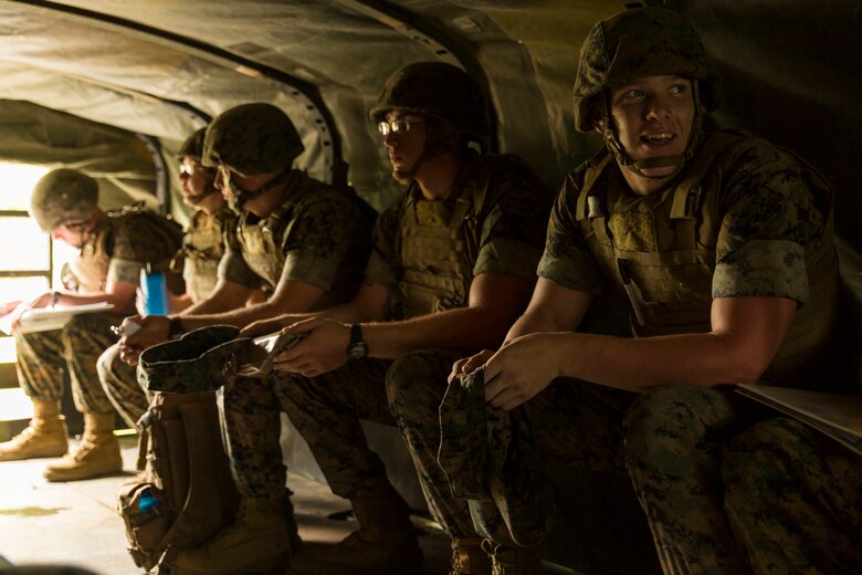 U.S. Marines with Marine Wing Support Squadron (MWSS) 171 ride in the back of a 7-ton medium tactical vehicle replacement during exercise Eagle Wrath 2016 at Combined Arms Training Center Camp Fuji, Japan, July 8, 2016. The squadron plans to complete their unit annual training requirements throughout three stages, which focuses on air base ground defense and Marine Corps common skills that Marines are unable to train for locally. Following the first stage Marines then start the ‘company training’ stage where company commanders have the opportunity to train their personnel and prepare for the final culminating event. (U.S. Marine Corps photo by Lance Cpl. Aaron Henson/Released)