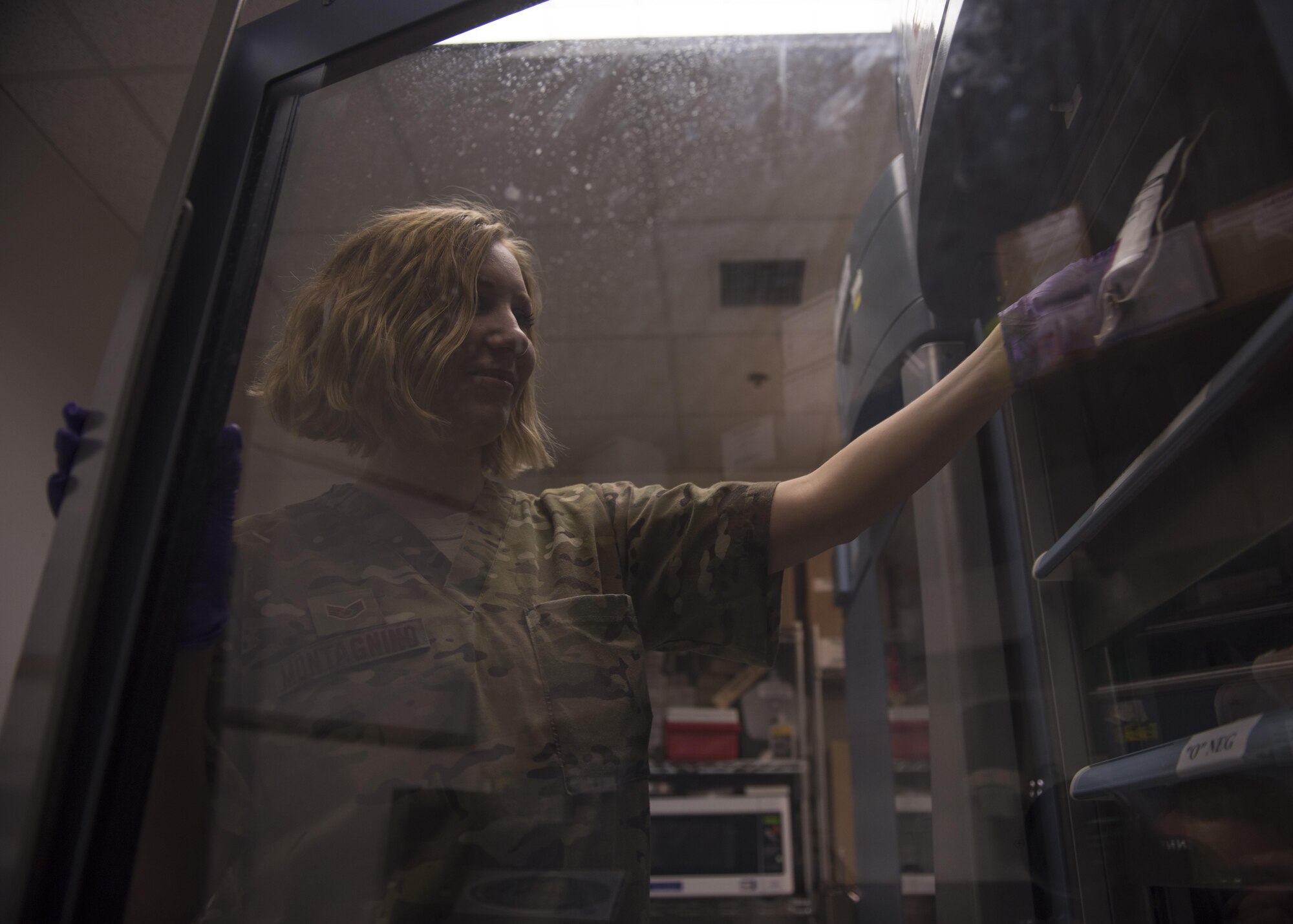Staff Sgt. Megan Montagnino, 455th Expeditionary Medical Group non-commissioned officer in charge of microbiology and the blood bank, takes a blood packet from storage, July 08, 2016, Bagram Airfield, Afghanistan. The blood bank keeps all components of blood in a cold storage to expand its already short shelf life. (U.S. Air Force photo by Senior Airman Justyn M. Freeman)