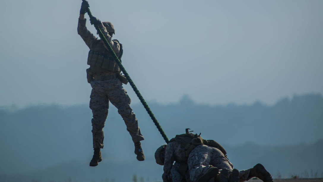 Marines with 2nd Battalion, 5th Marine Regiment, Weapons Company, Scout Sniper Platoon, fast rope from an MV-22B Osprey with Marine Medium Tiltrotor Squadron (VMM) 164 aboard Marine Corps Base Camp Pendleton, Calif., June 30. The ability to fast rope enables Marines to insert into an area or structure without landing the aircraft, eliminating the need for a landing zone.