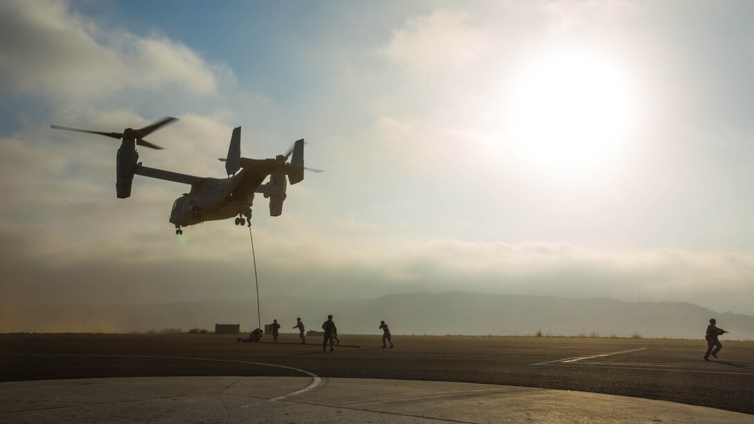Marines with 2nd Battalion, 5th Marine Regiment, Weapons Company, Scout Sniper Platoon, fast rope from an MV-22B Osprey with Marine Medium Tiltrotor Squadron 164 aboard Marine Corps Base Camp Pendleton, Calif., June 30. The ability to fast rope enables Marines to insert into an area or structure without landing the aircraft, eliminating the need for a landing zone. 