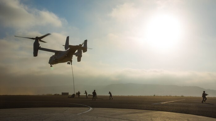 Marines with 2nd Battalion, 5th Marine Regiment, Weapons Company, Scout Sniper Platoon, fast rope from an MV-22B Osprey with Marine Medium Tiltrotor Squadron 164 aboard Marine Corps Base Camp Pendleton, Calif., June 30. The ability to fast rope enables Marines to insert into an area or structure without landing the aircraft, eliminating the need for a landing zone. 
