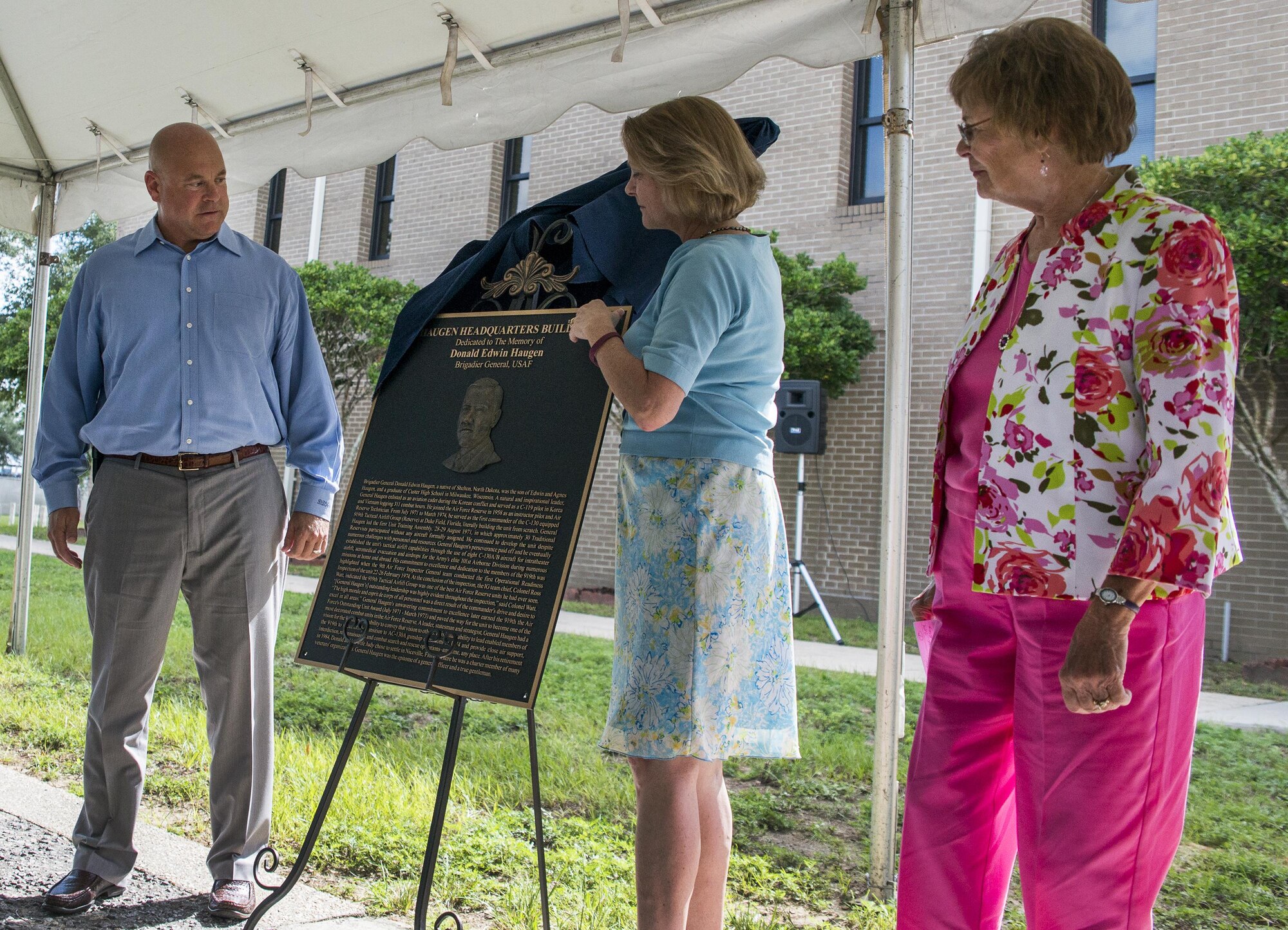 The family of retired Brig. Gen. Donald Haugen, unveil a bronze plaque at the 919th Special Operations Wing headquarters building dedication ceremony at Duke Field, Fla., July 8.  The building was dedicated to the 919th’s founding member, Haugen, who created the 919th Tactical Airlift Group in 1971.  The plaque will be placed on the outside of the newly-named Haugen Headquarters.  (U.S. Air Force photo/Tech. Sgt. Sam King)