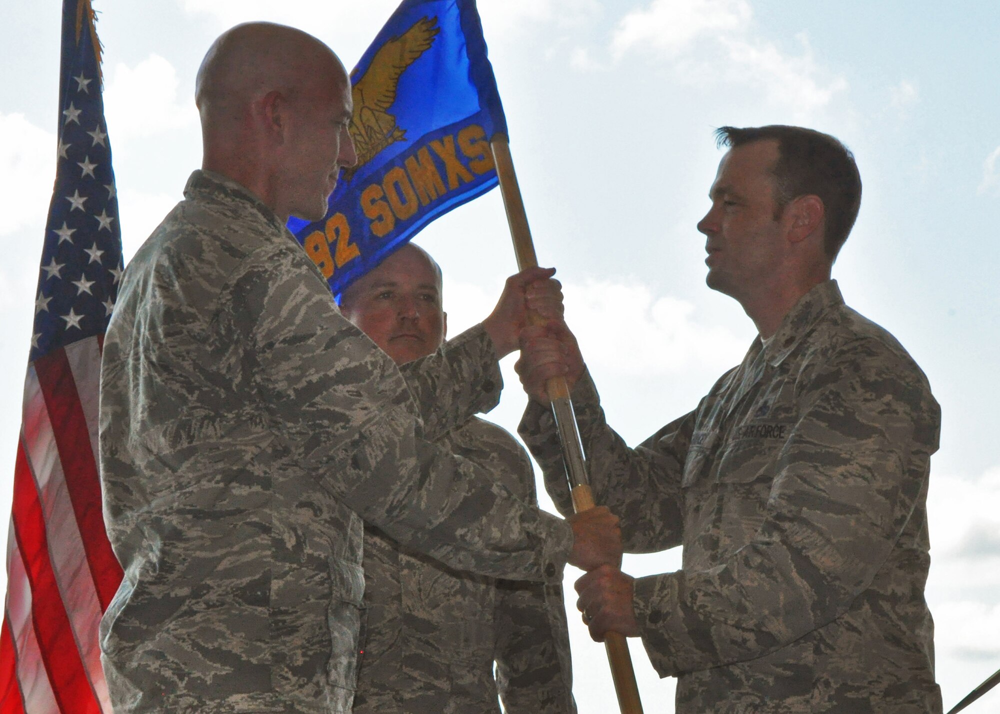 Maj. David Chancey accepts the 592nd Special Operations Maintenance Squadron guidon from Col. David Tabor, the Air Force Special Operations Air Warfare Center commander, during the squadron's change of command ceremony at Duke Field, June 27.  The 592nd an active-duty maintenance counterpart to the 919th Special Operations Maintenance Squadron.  Both units are part of the 919th Special Operations Maintenance Group.