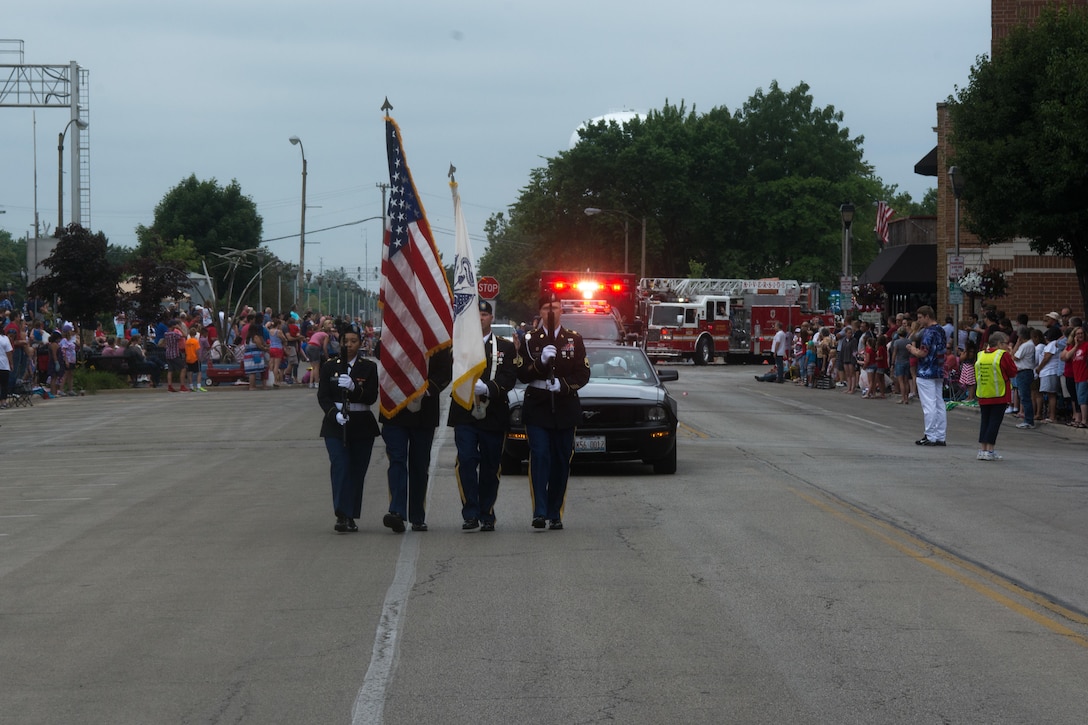 From left, Spc. Abigail Billups, Staff Sgt. Luis Lopez, Sgt. Stephen Galvin, and Staff Sgt. Adam Tracy, all assigned to the 416th Theater Engineer Command, march through Brookfield, Illinois, as members of the color guard, during the Independence Day parade, Jul. 4, 2016. (U.S. Army photo by Staff Sgt. Jason Proseus/Released)