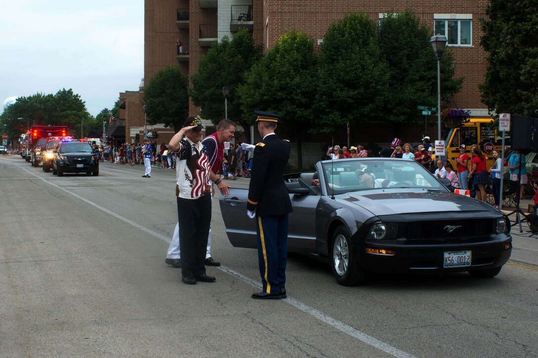 John Curin, left, a Korean War Combat Veteran and Grand Marshall of the Brookfield, Illinois Independence Day parade, salutes Cpt. Zachary Galaboff, commander of Headquarters and Headquarters Company (HHC) 416th Theater Engineer Command, Jul. 4, 2016. (U.S. Army photo by Staff Sgt. Jason Proseus/Released)