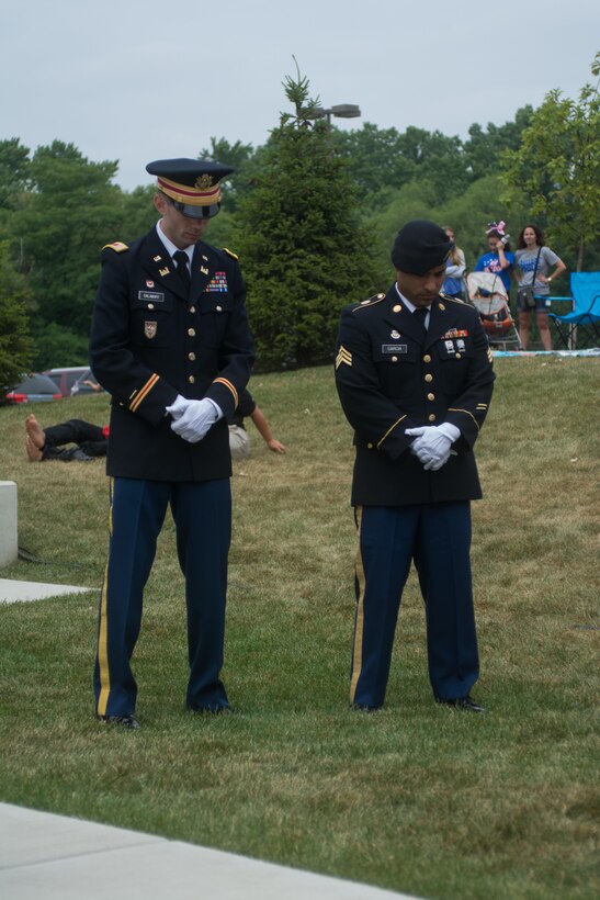 Cpt. Zachary Galaboff, left, and Sgt. Peter Garcia, both assigned to the 416th Theater Engineer Command, bow their heads in reverence as the invocation is made. The invocation marks the beginning of the Independence Day festivities in Brookfield, Illinois, Jul. 4, 2016. (U.S. Army photo by Staff Sgt. Jason Proseus/Released)