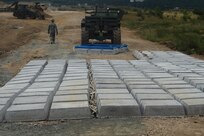 Soldiers with the 841st Engineer Battalion, U.S. Army Reserve reinforce a heavily-used road at Novo Selo Training Area, Bulgaria on July 2nd, 2016 during Operation Resolute Castle.  To improve these portions of road, the 841st Engineer Battalion installs materials known as “articulated concrete block,” pieces of concrete block connected by rope-like cables, and covering the concrete with gravel.  (U.S. Army photo by Capt. Kimberlee Lewis, 841st Engineer Battalion, United States Army Reserve)