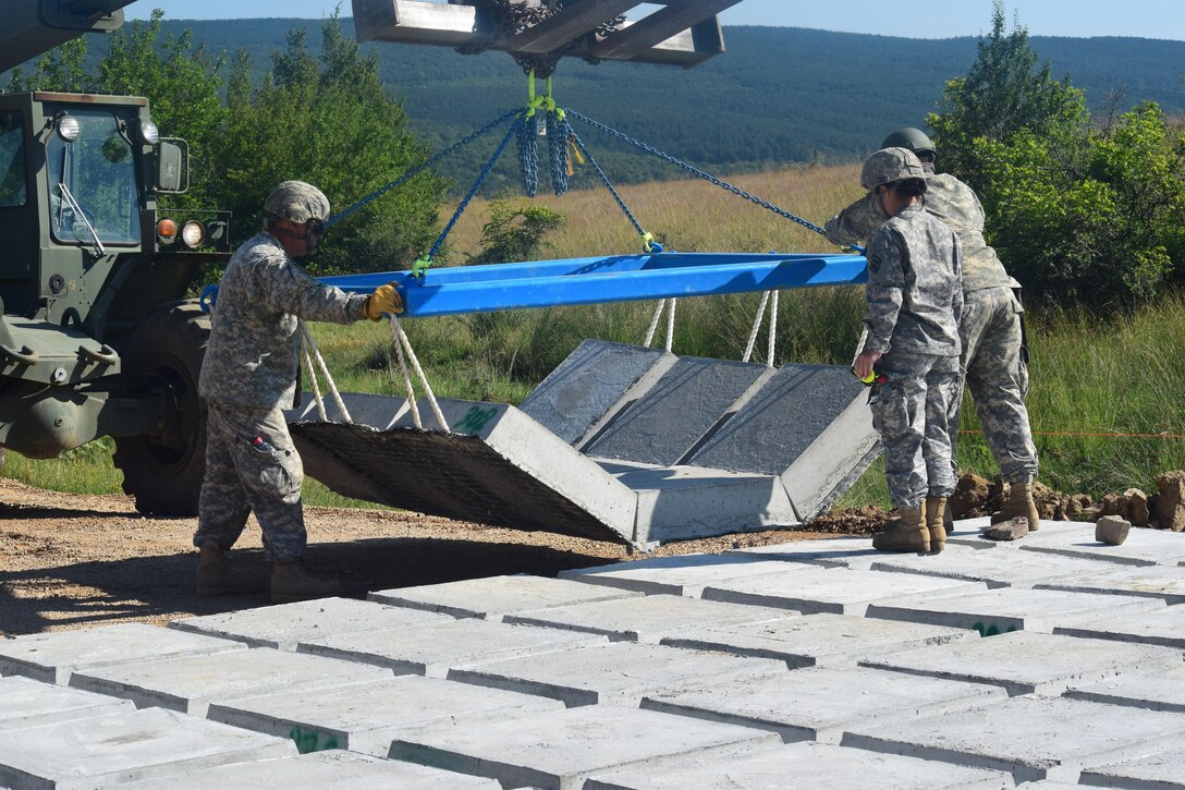 Soldiers with the 841st Engineer Battalion, U.S. Army Reserve reinforce are using a 10,000 lbs forklift to move “articulated concrete block,” pieces of concrete block connected by rope-like cables, and covering the concrete with gravel to improve on a heavily-used road at Novo Selo Training Area, Bulgaria on July 2nd, 2016 during Operation Resolute Castle. (U.S. Army photo by Capt. Kimberlee Lewis, 841st Engineer Battalion, United States Army Reserve)