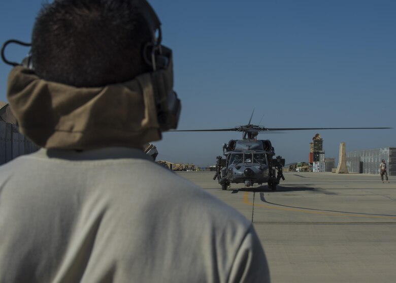 Airman 1st Class Raul Perales, 455th Expeditionary Aircraft Maintenance Squadron HH-60 crew cheif, prepares to marshal a HH-60G Pave Hawk, June 08, 2016, Bagram Airfield, Afghanistan. Perales marshals the pilots as they prepare to participate in a personnel recovery exercise.  (U.S. Air Force photo by Senior Airman Justyn M. Freeman)