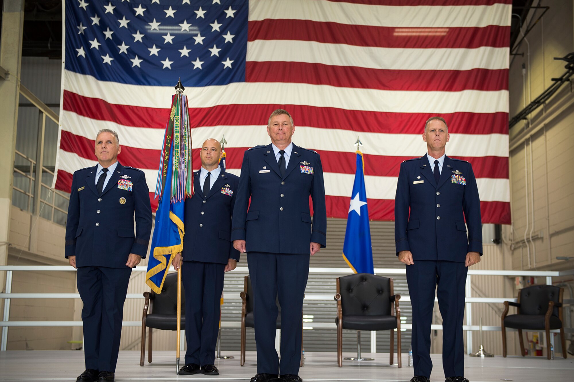 From left to right, Maj. Gen. John Flournoy, 4th Air Force commander, retired Col. Douglas Schwartz, outgoing 434th Air Refueling Wing commander, Col. Larry Shaw, 434th ARW commander, and behind Chief Master Sgt. Robert Herman, 434th ARW command chief, stand at attention during a change of command ceremony at Grissom Air Reserve Base, Ind., July 9, 2016.  The formal ceremony was held in front of wing Airmen as is the military tradition. (U.S. Air Force Photo/ Tech. Sgt. Benjamin Mota)  