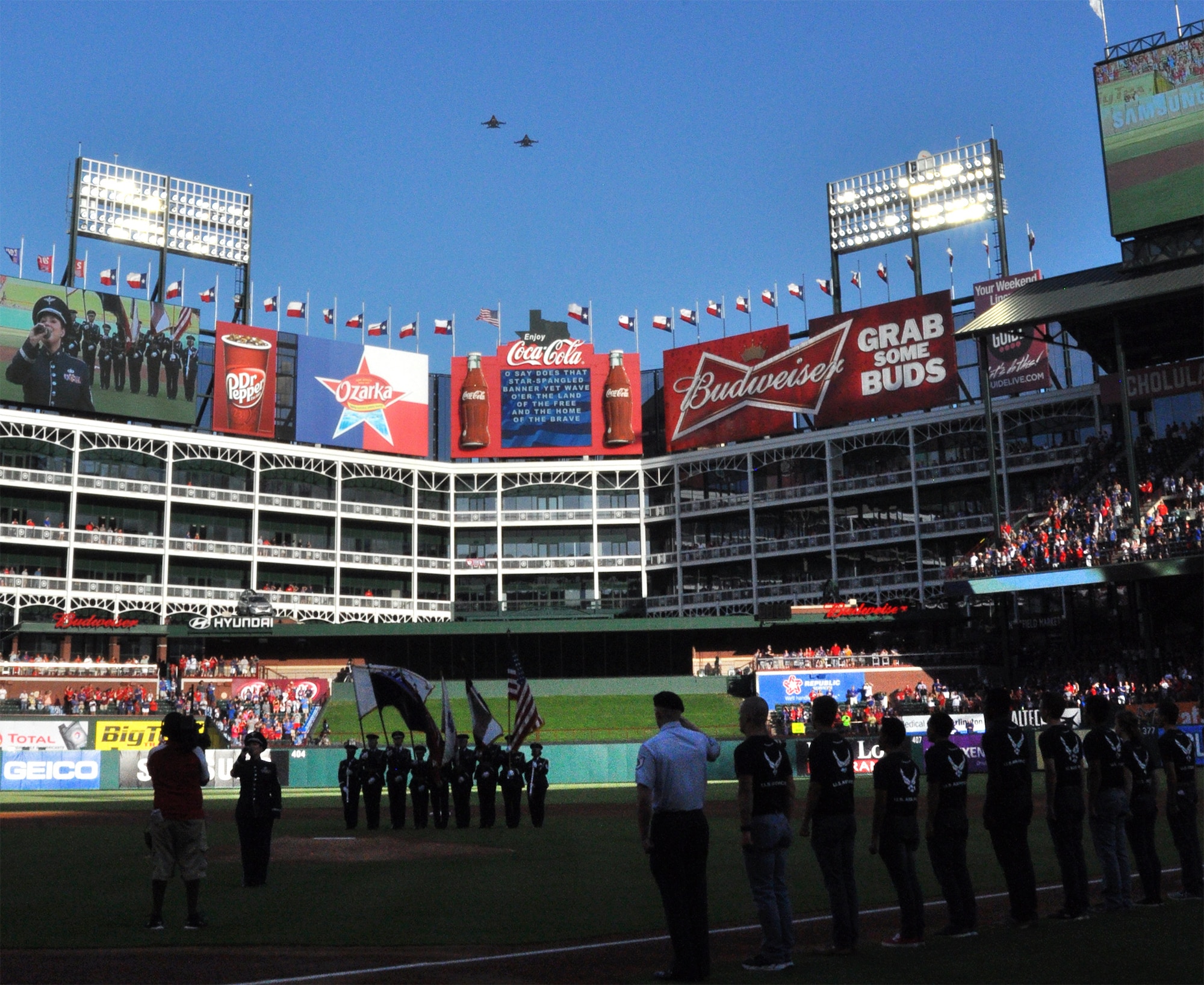 The 301 Fighter Wing’s hometown built F-16s flyover Globe Life Park in Arlington, Texas, before the start of last night’s Texas Ranger game against the Minnesota Twins. Before the game, Lt. Col. Tracy Parrish, 344th Air Force Recruiting Squadron commander, administered the oath of enlistment to 150 new recruits followed by 531st Air Force Band member Master Sgt. Shonda Winkler’s rendition of the National Anthem. (U.S. Air Force photo by Ms. Julie Briden-Garcia)