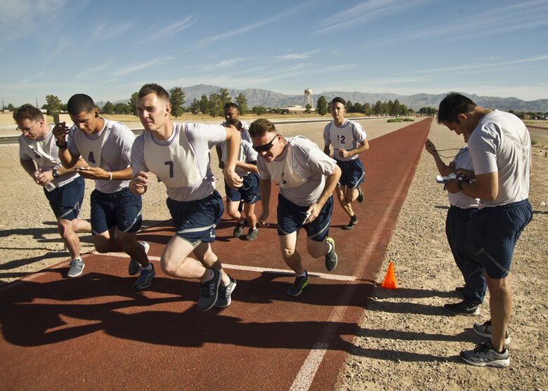 Staff Sgt. Luis Valencia, 926th Force Support Squadron Fitness Assessment Cell physical training leader, prepares to track the times of 926th Wing members as they begin the running portion of their fitness test. The 926th FSS supports the fitness testing of 926th Wing members and provides specialized culinary training for  new services Airmen whose career focus is food services.