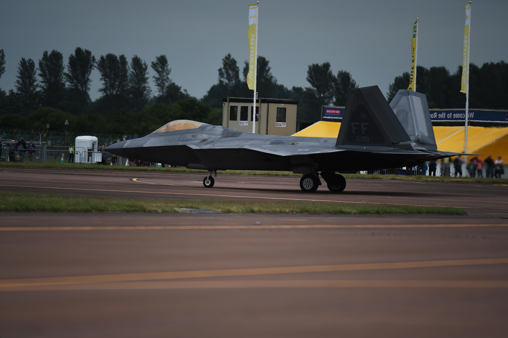 A F-22 Raptor, with the Raptor Demonstration Team, taxis past onlookers prior to its performance at the Royal International Air Tattoo, hosted on RAF Fairford, July 8-10, 2016. RIAT 16 afforded an opportunity for new aircraft, like the F-35 Lightning II, to be displayed alongside crowd favorites and provided a weekend of fun and entertainment for the projected 160,000 visitors. (U.S. Air Force photo by Airman 1st Class Zachary Bumpus/Released)