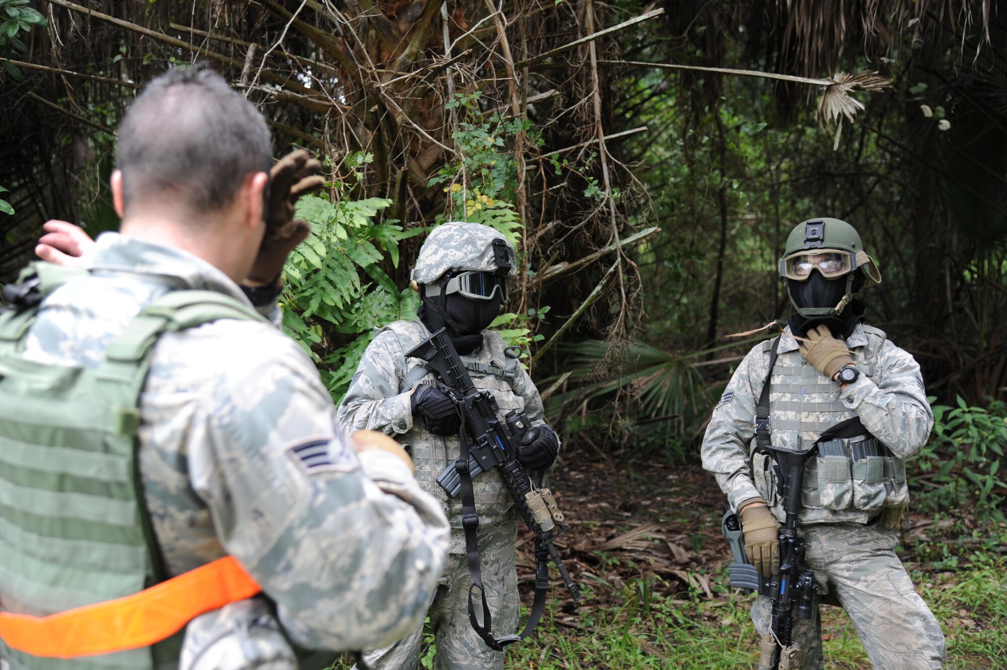 Members of the 927th Security Forces Squadron fire team discuss their previous training scenario as part of a training exercise at Avon Park Air Force Range, FL., July 10, 2016. The purpose of the training scenario was to enhance the fire team’s skills for use against opposing forces. (U.S. Air Force photo by Tech Sgt. Peter Dean/Released)