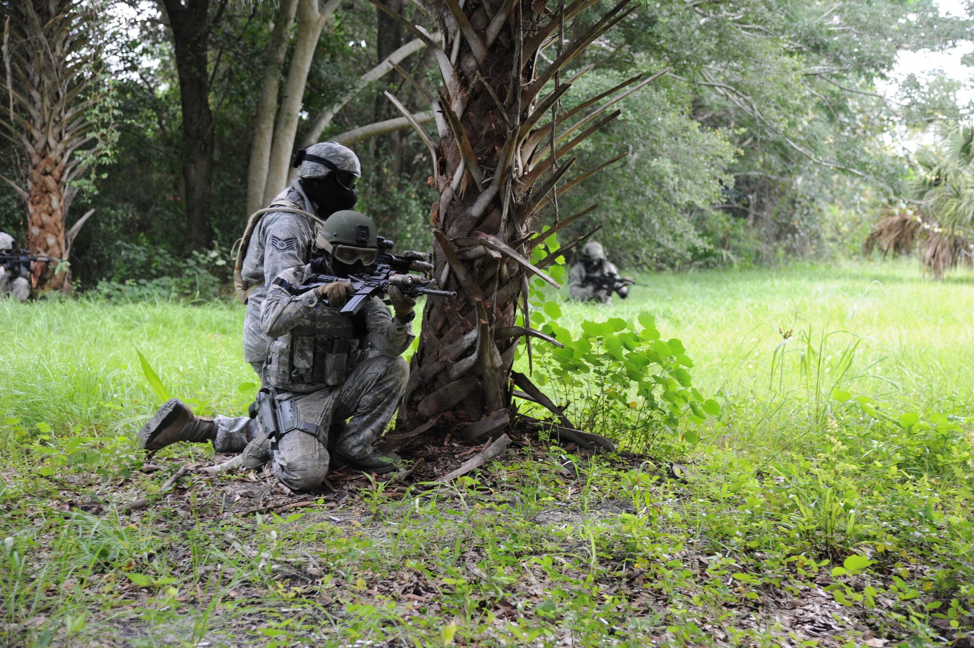 Members of the 927th Security Forces Squadron fire team are set in position during a training exercise held at Avon Park Air Force Range, FL., July 10, 2016.The goal of the training was to provide real life scenarios for members who may encounter similar attacks while deployed. (U.S. Air Force photo by Tech Sgt. Peter Dean/Released)