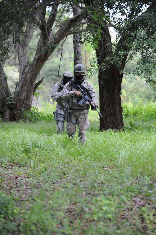 Members of the 927th Security Forces Squadron fire team run to gain cover as part of a training exercise at Avon Park Air Force Range, FL., July 10, 2016. The Airmen participated in a series of scenarios that help prepare them for possible situations in a deployed environment. (U.S. Air Force photo by Tech Sgt. Peter Dean/Released) 