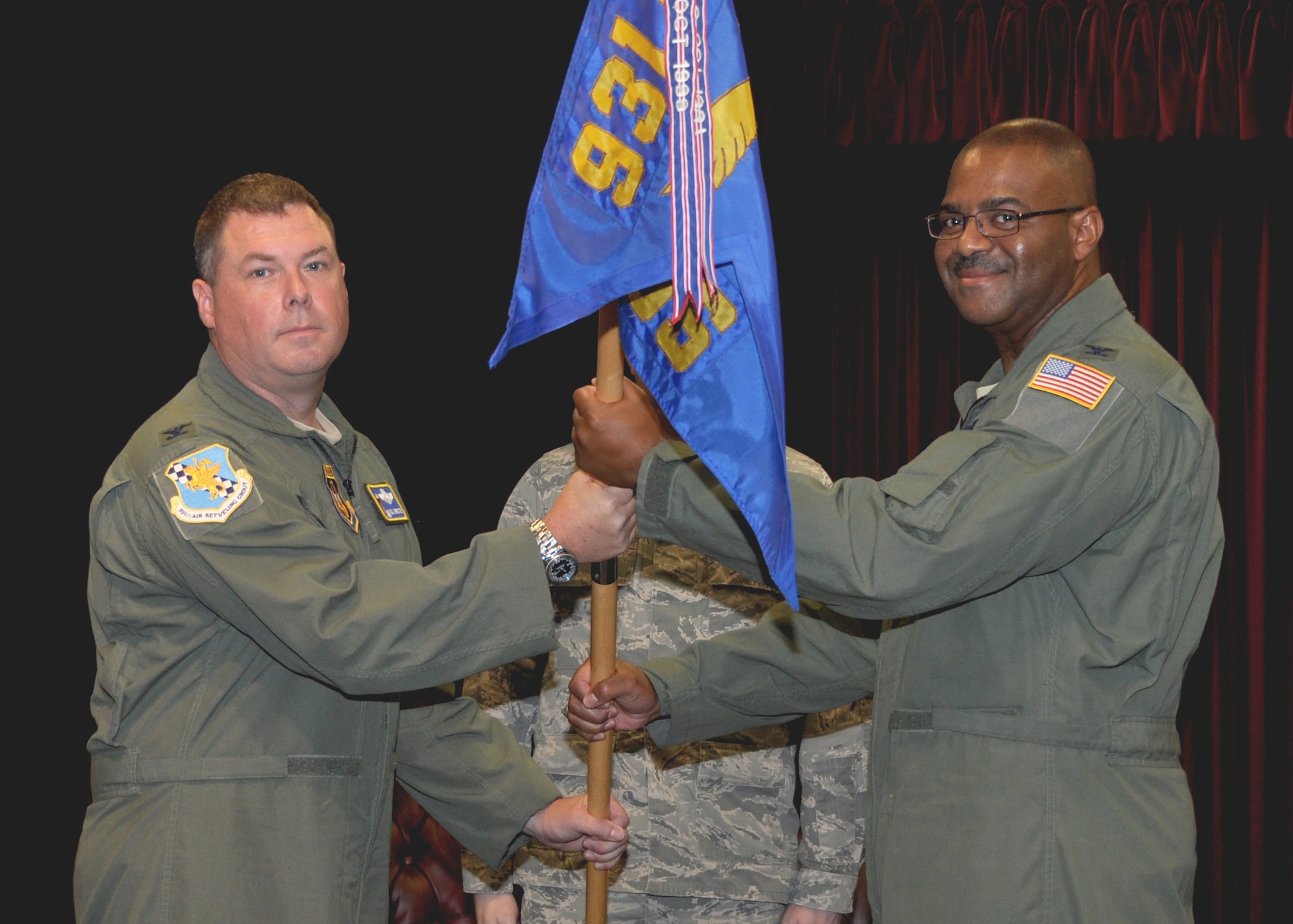 Col. Richard Webster, left, 931st Operations Group Commander, receives the 931st Operations Support Squadron guidon from Col. Esteban "Esty" L. Ramirez, 931 OSS outgoing commander, during the 931 OSS change of command ceremony July 10, 2016, McConnell Air Force Base, Kan. The physical passing of the unit guidon represents the transfer of authority from one commander to the next. (U.S. Air Force photo by Senior Airman Preston Webb)