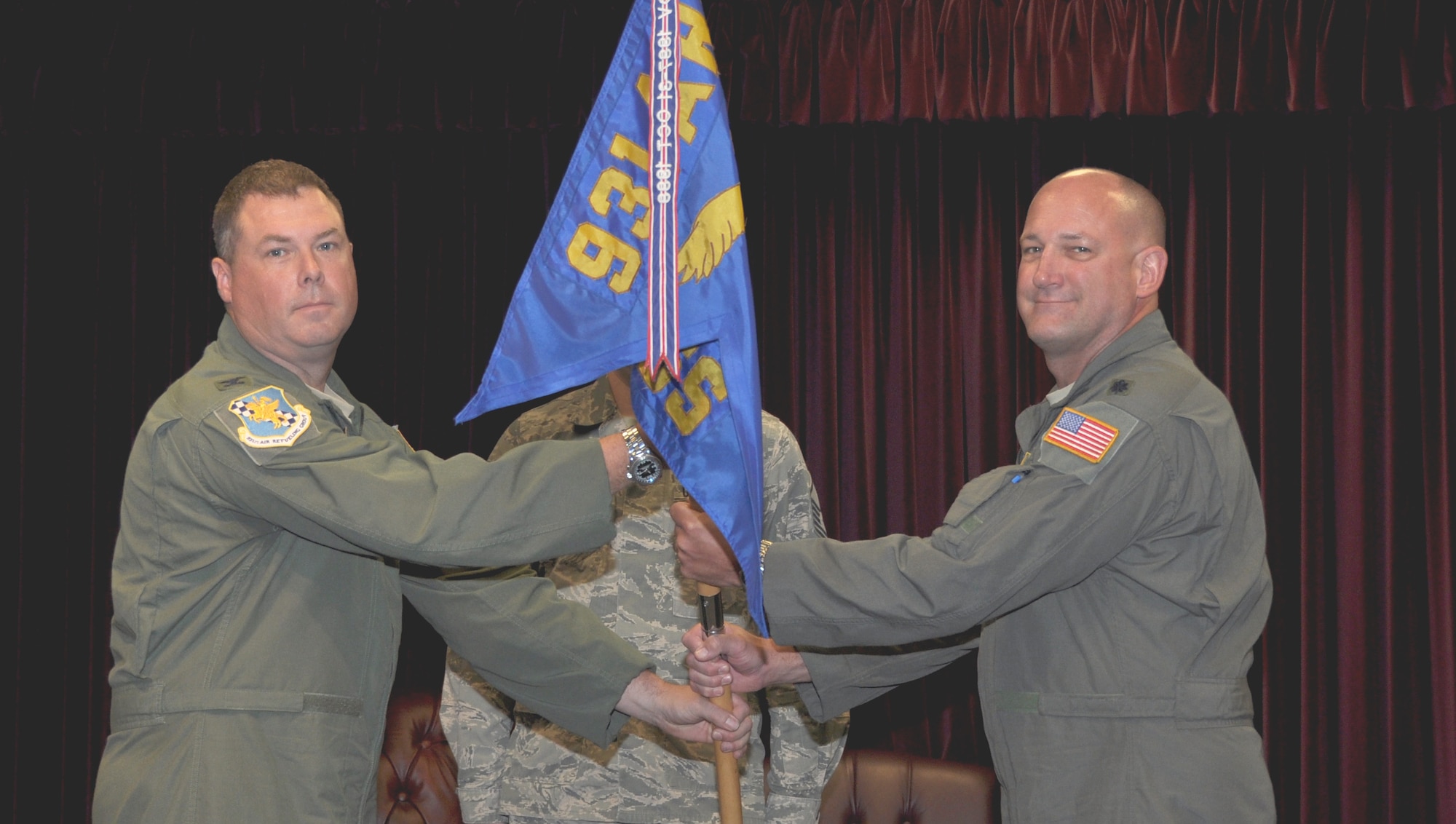 Col. Richard Webster, left, 931st Operations Group Commander, passes the 931st Operations Support Squadron guidon to Lt. Col. Kevin L. Rainey, 931 OSS commander, during the 931 OSS change of command ceremony July 10, 2016, McConnell Air Force Base, Kan. The military change of command ceremony dates back to Frederick the Great of Prussia. (U.S. Air Force photo by Senior Airman Preston Webb)
