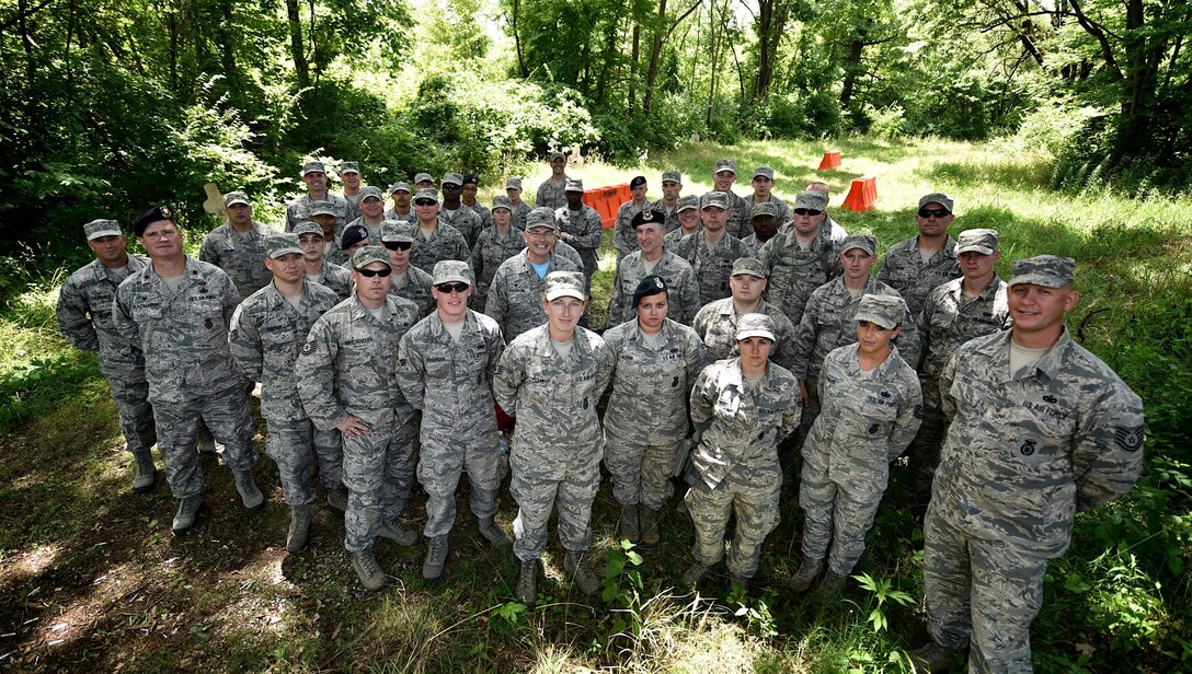 Men and women from the  932nd Airlift Wing Security Forces Squadron take time out during a busy training weekend and stand with Col. Jonathan Philebaum, 932nd AW commander, second row center, and Col. Timothy Donnelly, deputy chief of security forces division, headquarters Air Force Reserve Command, Robins Air Force Base, Georgia, July 9, 2016, Scott Air Force Base, Illinois. Donnelly spoke to the Airmen between training to discuss current affairs within Security Forces and address any concerns or questions.  (U.S. Air Force photo/Tech. Sgt. Christopher Parr)