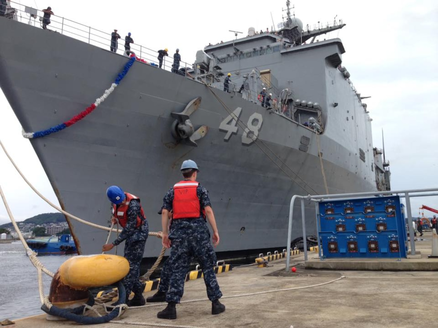 SASEBO, Japan (July 08, 2016) Sailors from port operations handle line as the amphibious dock landing ship USS Ashland (LSD 48) is moored to the pier. Ashland, part of Amphibious Force 7th Fleet, is returning from a recent patrol in support of the 2016 Cooperation Afloat Readiness and Training series. (U.S. Navy photo by Mass Communication Specialist 3rd Class Krystina Coffey /Released)