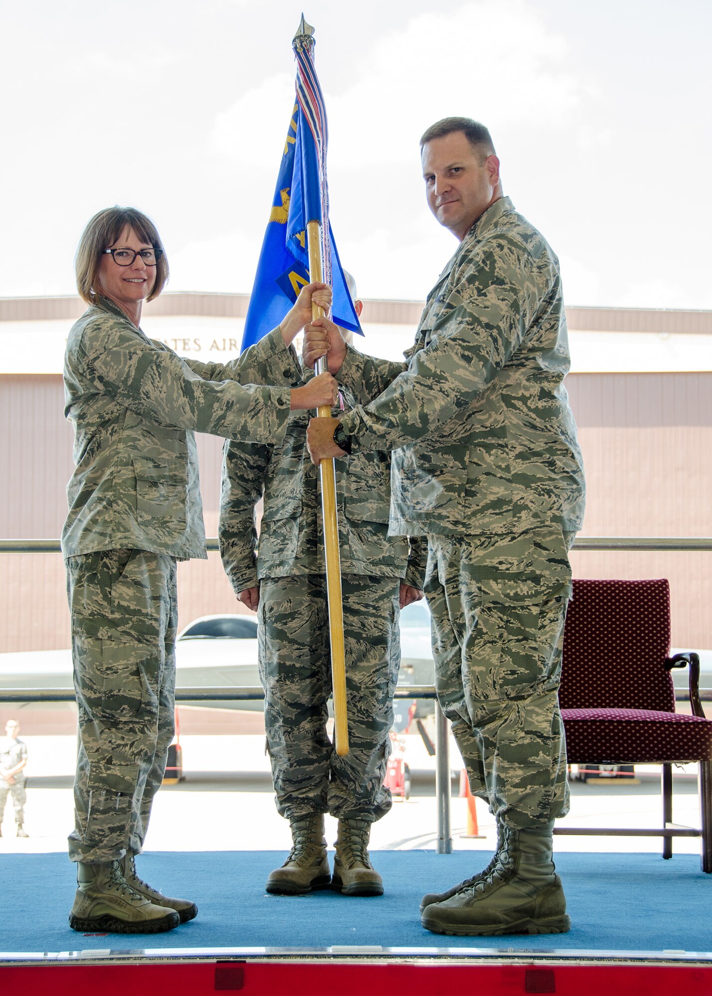 Lt. Col. Michael Belardo, the new 131st Aircraft Maintenance Squadron commander, takes the guidon from Col. Kimbra Sterr, commander of the 131st Maintenance Group during a change of command ceremony during the Missouri Air National Guard's 131st Bomb Wing July drill weekend at Whiteman Air Force Base, Missouri. Belardo, previously the director of operations for the 509th Operations Support Squadron, is replacing outgoing squadron commander Lt. Col. Matthew Calhoun, who will serve as the new 131st BW vice commander. (U.S. Air National Guard photo by Airman 1st Class Halley Burgess)