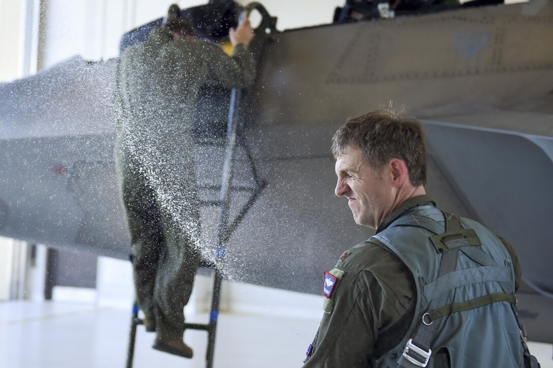 Air Force Col. David Piffarerio receives a ceremonial hose down after his final flight as 477th Fighter Group commander on Joint Base Elmendorf-Richardson, Alaska, July 8, 2016. Air Force photo by Senior Airman James Richardson